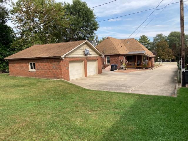 exterior space with a yard and a garage