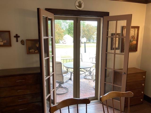 entryway with light hardwood / wood-style floors and french doors