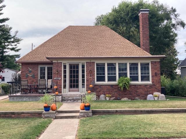 back of property featuring a lawn and a patio