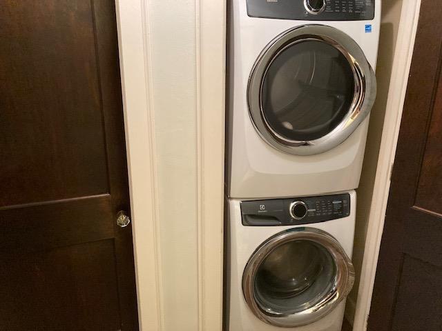 laundry area with stacked washer / dryer