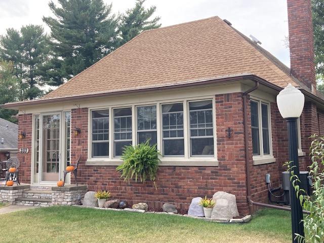 view of side of home with a lawn