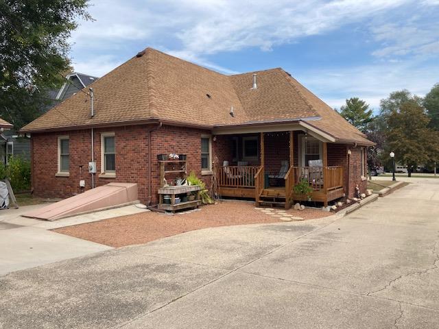 back of property with covered porch