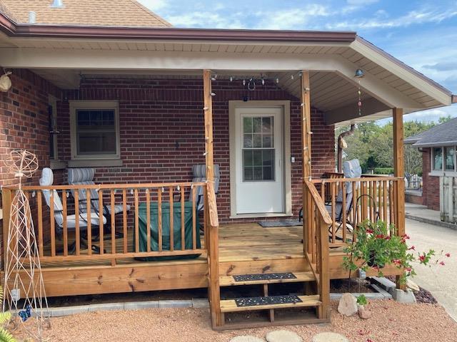 view of exterior entry with a deck