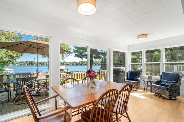 sunroom / solarium featuring a water view