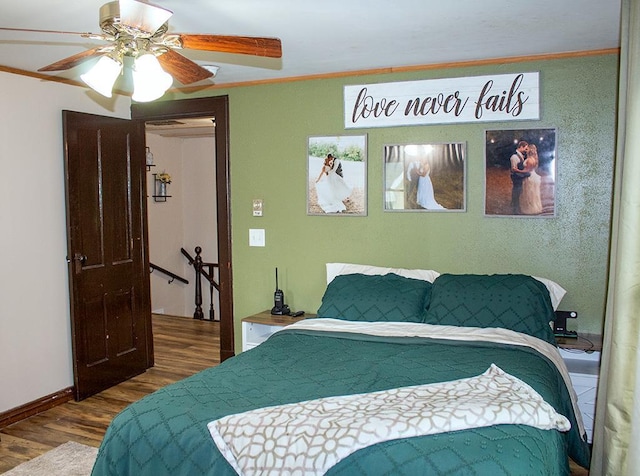 bedroom featuring wood-type flooring, crown molding, and ceiling fan