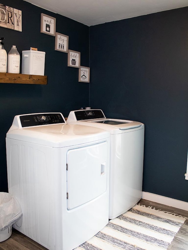 laundry area with hardwood / wood-style floors and washer and dryer