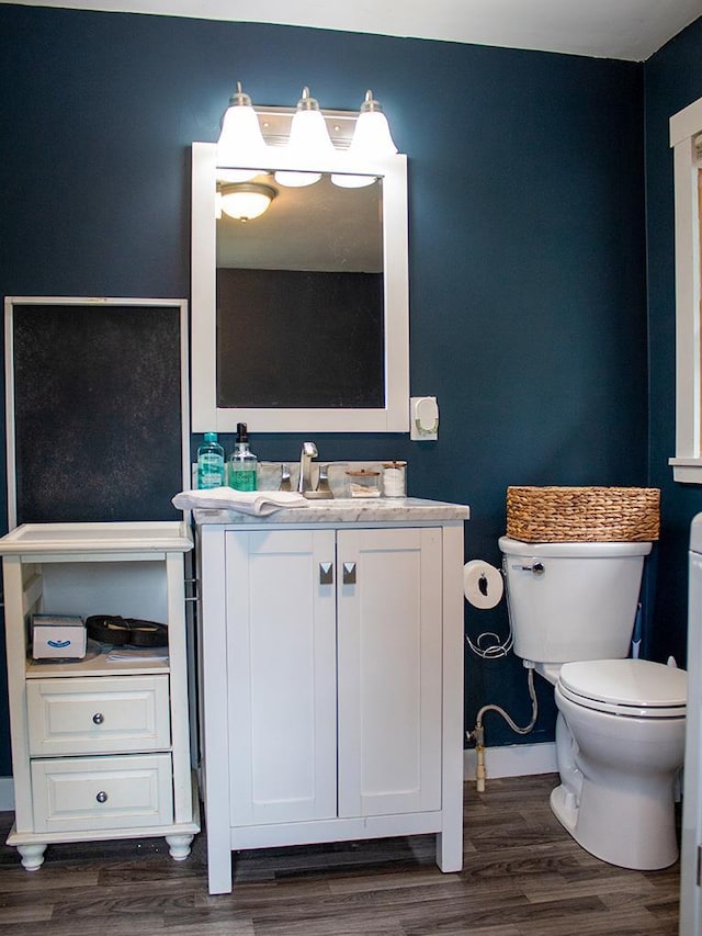 bathroom featuring hardwood / wood-style flooring, vanity, and toilet