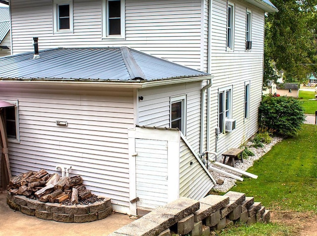 view of home's exterior featuring cooling unit and a lawn