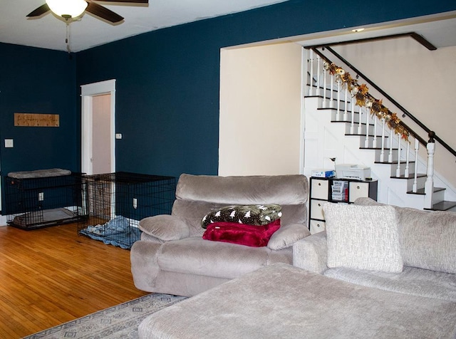 living room featuring ceiling fan and hardwood / wood-style flooring