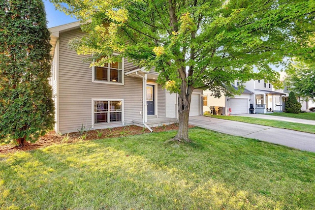 view of front of home with a garage and a front lawn