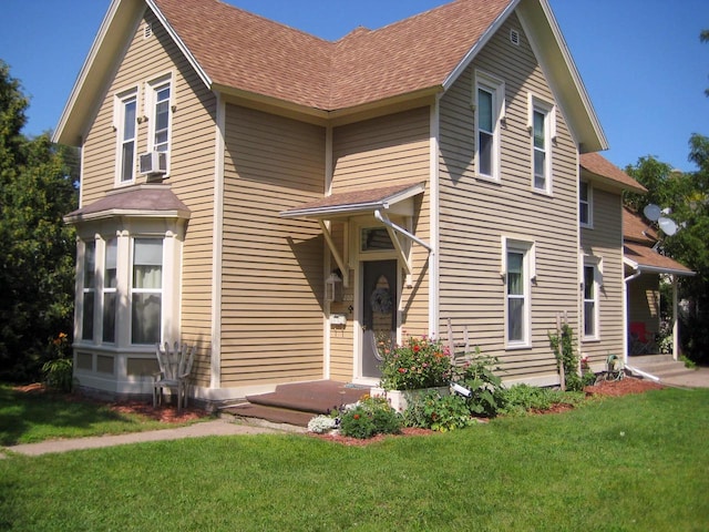 front of property featuring cooling unit and a front yard