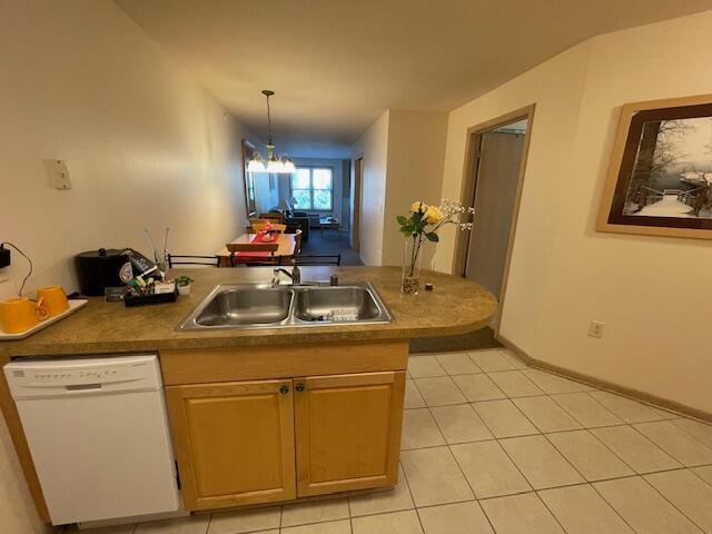 kitchen with light tile patterned flooring, sink, decorative light fixtures, dishwasher, and a notable chandelier