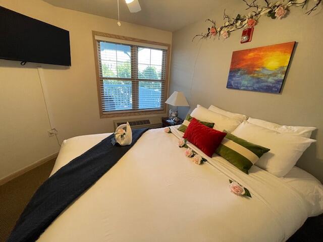 carpeted bedroom featuring ceiling fan