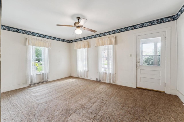 entrance foyer featuring carpet and ceiling fan