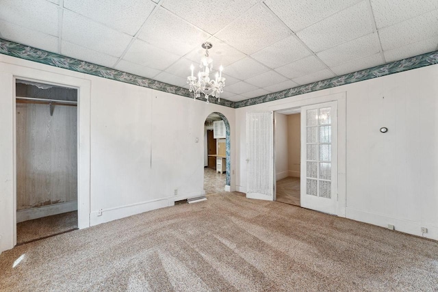 unfurnished bedroom featuring a closet, a paneled ceiling, and carpet flooring