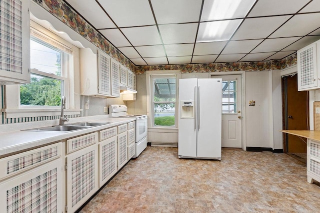 kitchen featuring white appliances, white cabinetry, a healthy amount of sunlight, and sink