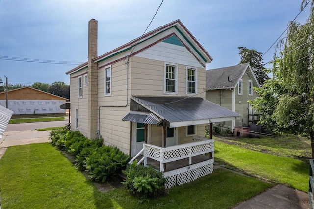 view of front of home with covered porch and a front yard