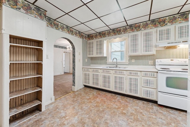 kitchen with electric stove, white cabinetry, a paneled ceiling, and sink