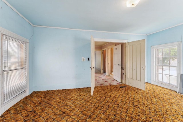 empty room featuring ornamental molding