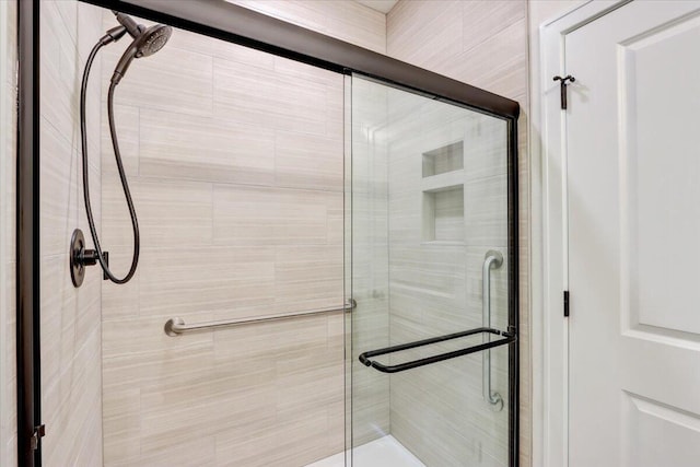 bathroom featuring a shower with shower door