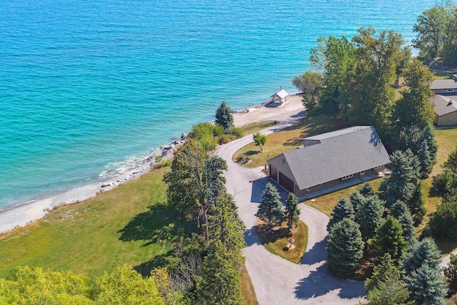 birds eye view of property with a water view and a view of the beach