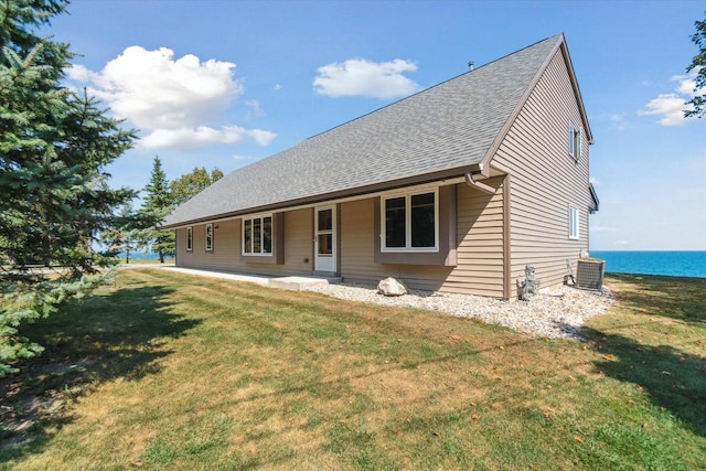 7001 Novak Rd, Racine, WI 53402 - back of property featuring a shingled roof, a yard, a water view, and central AC unit