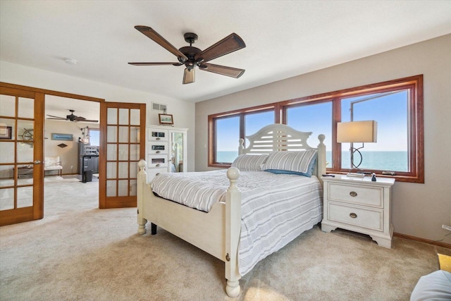 7001 Novak Rd, Racine, WI 53402 - bedroom featuring french doors, light carpet, baseboards, and ceiling fan