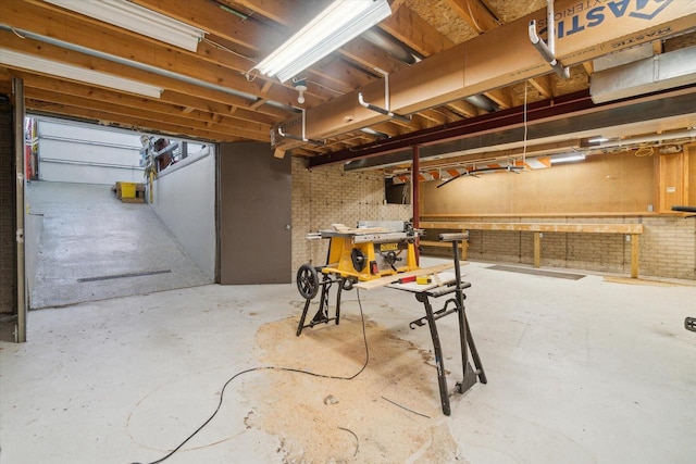 7001 Novak Rd, Racine, WI 53402 - unfinished basement featuring a workshop area and brick wall
