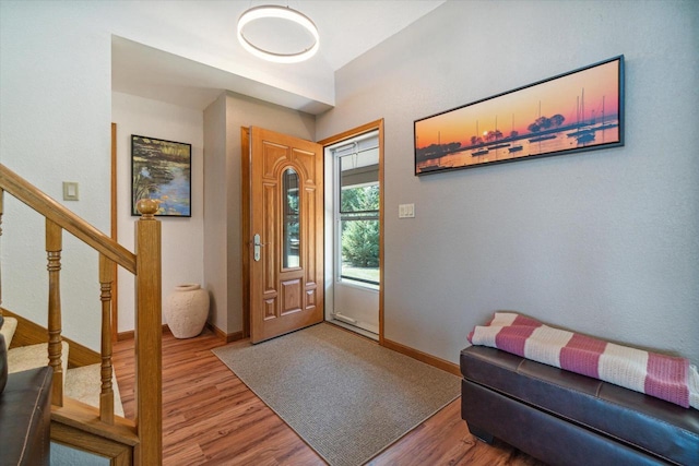 7001 Novak Rd, Racine, WI 53402 - foyer entrance featuring wood finished floors, stairway, and baseboards