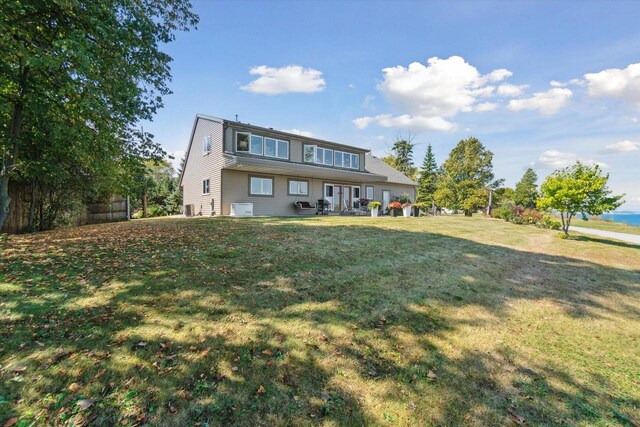 7001 Novak Rd, Racine, WI 53402 - rear view of property featuring a lawn and a patio