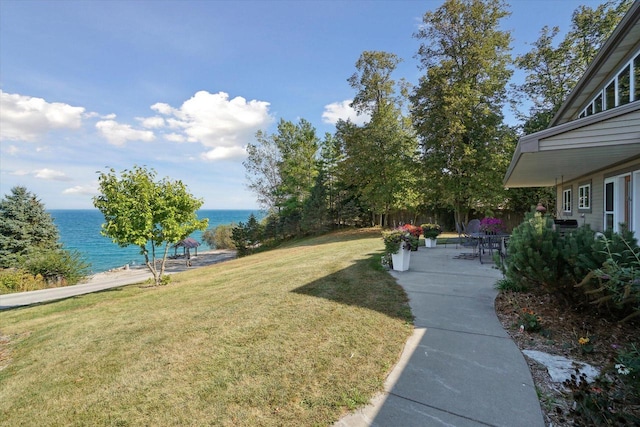 7001 Novak Rd, Racine, WI 53402 - view of grassy yard featuring a water view and a patio area