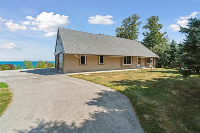 7001 Novak Rd, Racine, WI 53402 - view of front of property with asphalt driveway, a garage, a front lawn, a porch, and a shingled roof