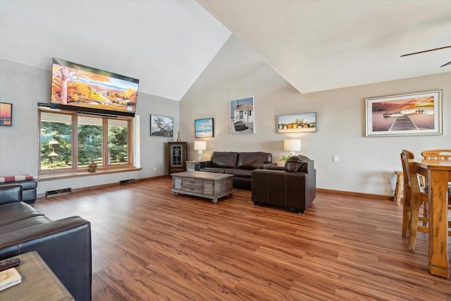 7001 Novak Rd, Racine, WI 53402 - living area with wood finished floors, high vaulted ceiling, baseboards, and ceiling fan