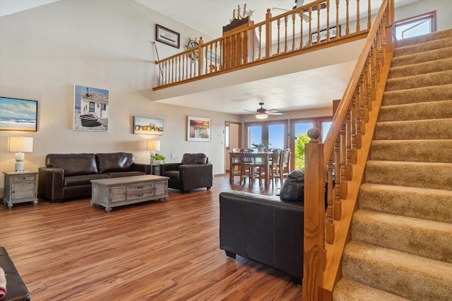 7001 Novak Rd, Racine, WI 53402 - living room featuring wood finished floors, stairway, a ceiling fan, and a high ceiling