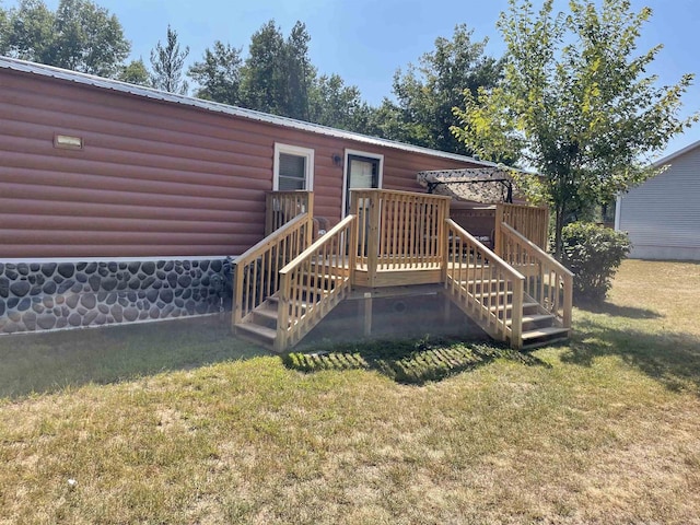 rear view of house with a lawn and a deck