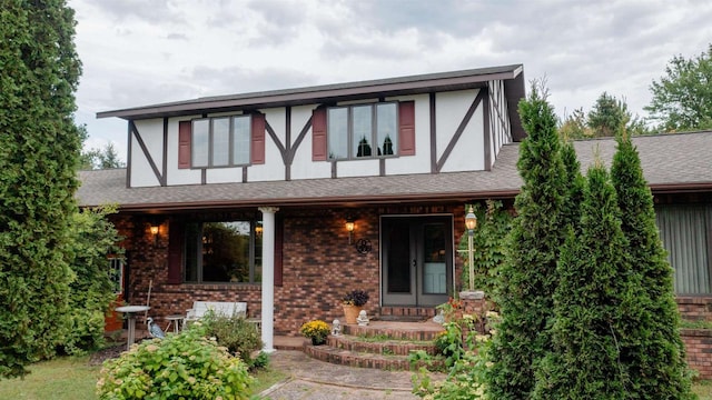 tudor home featuring a porch