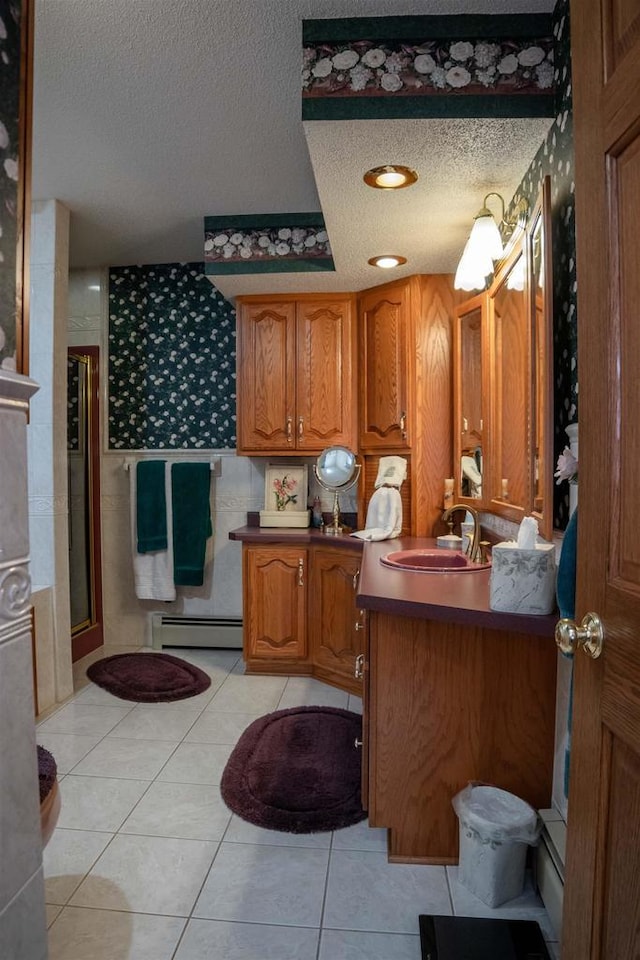 bathroom featuring tile patterned floors, vanity, a textured ceiling, baseboard heating, and a shower with shower door