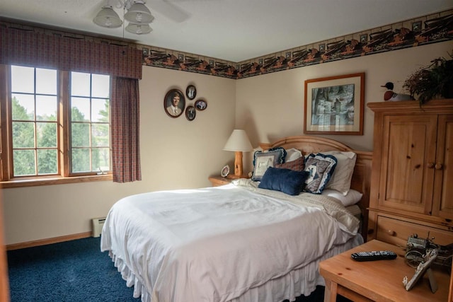 bedroom with carpet floors, baseboard heating, and ceiling fan