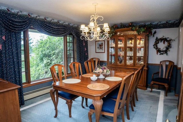 dining room featuring a notable chandelier and baseboard heating