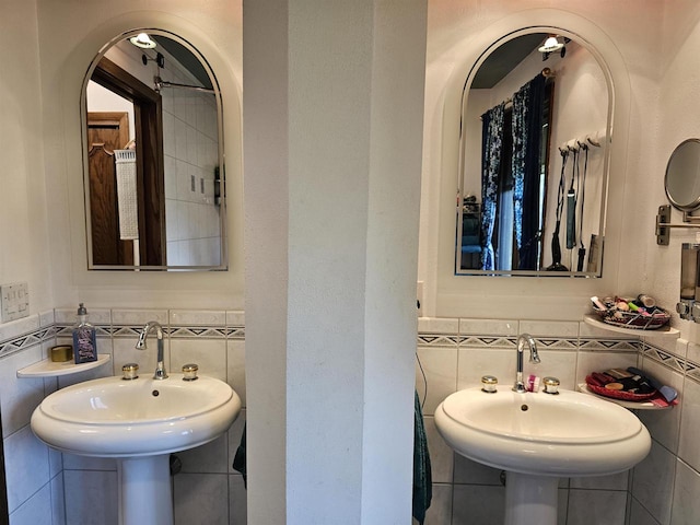 bathroom featuring tile walls and sink