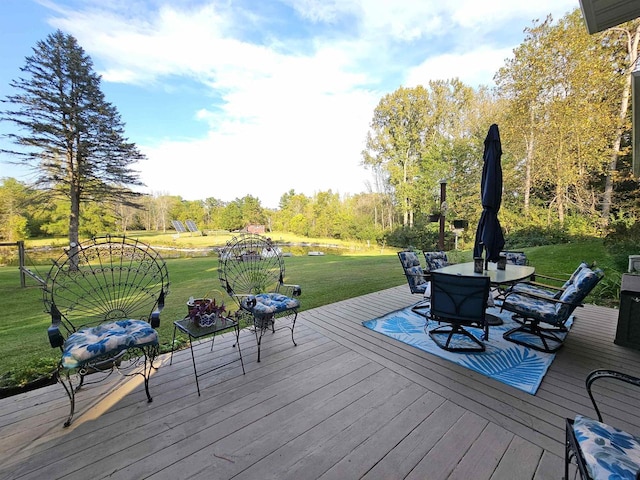 wooden terrace with a lawn