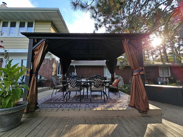 wooden terrace featuring a gazebo