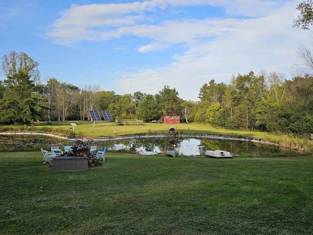 view of yard with a water view and a storage unit