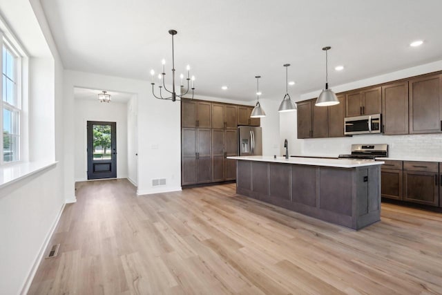 508 Hickory Hollow Rd Unit 0202, Waterford, WI 53185 - kitchen with decorative light fixtures, stainless steel appliances, and a wealth of natural light