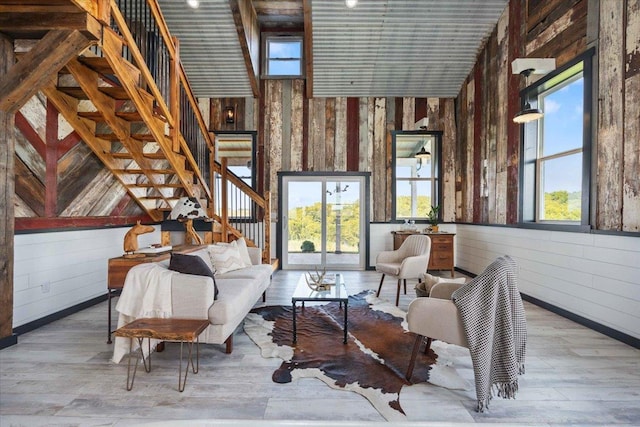 sitting room with wood walls and light hardwood / wood-style flooring