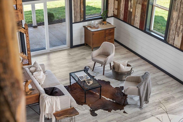 interior space featuring light hardwood / wood-style flooring and wood walls