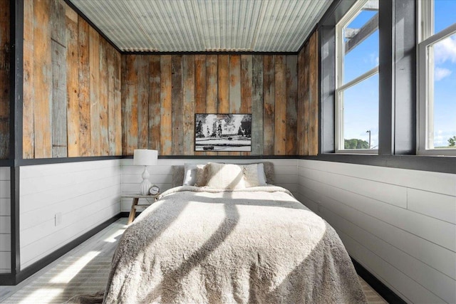 bedroom with wooden walls