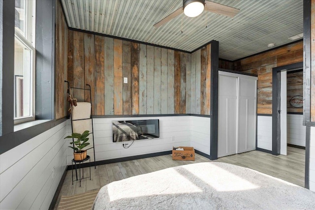 bedroom featuring light hardwood / wood-style flooring, wooden ceiling, and wood walls