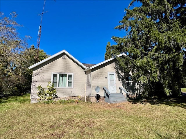 view of home's exterior with a yard