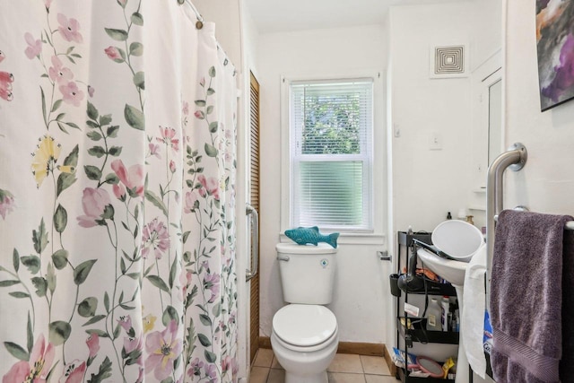 bathroom featuring tile patterned flooring, toilet, and a shower with shower curtain